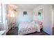 Bedroom with floral bedding, full-length mirror, and floor lamp at 4358 Raynham St, Las Vegas, NV 89115