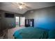 Large bedroom with ensuite bathroom and a teal duvet cover at 4358 Raynham St, Las Vegas, NV 89115