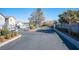 Gated community entrance with landscaping and paved roadway at 4358 Raynham St, Las Vegas, NV 89115