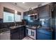 Updated kitchen, featuring dark cabinets and hexagon backsplash at 4358 Raynham St, Las Vegas, NV 89115