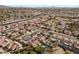 Aerial view showing a neighborhood with houses, streets, and palm trees at 4609 Snowpoint Ct, Las Vegas, NV 89130