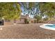 Large backyard with gravel landscaping and a pool at 4609 Snowpoint Ct, Las Vegas, NV 89130