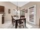 Bright dining area with wood table and chairs near sliding door at 4609 Snowpoint Ct, Las Vegas, NV 89130