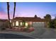 Single-story house with tan walls, tile roof, and a two-car garage at 4609 Snowpoint Ct, Las Vegas, NV 89130