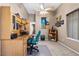 Home office with wood desk, teal chair, and built-in shelving at 4609 Snowpoint Ct, Las Vegas, NV 89130