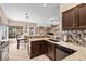 Spacious kitchen with granite countertops and dark wood cabinetry at 4609 Snowpoint Ct, Las Vegas, NV 89130