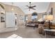 Bright living room with high ceilings, L-shaped sectional sofa, and built-in shelving at 4609 Snowpoint Ct, Las Vegas, NV 89130