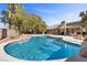 Refreshing kidney-shaped pool surrounded by desert landscaping at 4609 Snowpoint Ct, Las Vegas, NV 89130