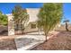 Backyard with covered patio, landscaping, and a view of the house at 4861 Camino Sombrero, North Las Vegas, NV 89031