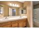 Bathroom with double sinks, wood cabinets, and a separate shower and tub at 4861 Camino Sombrero, North Las Vegas, NV 89031