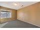 Well-lit bedroom with gray carpet and window view at 4861 Camino Sombrero, North Las Vegas, NV 89031