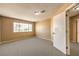 Simple bedroom with gray carpet and large window at 4861 Camino Sombrero, North Las Vegas, NV 89031