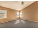 Spacious bedroom with gray carpeting and multiple windows at 4861 Camino Sombrero, North Las Vegas, NV 89031