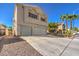 Two-story house with a three-car garage and landscaping at 4861 Camino Sombrero, North Las Vegas, NV 89031