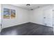 Bedroom with neutral paint, dark laminate floors, and a large window at 4981 Alondra Dr, Las Vegas, NV 89118