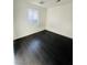 Simple bedroom with dark hardwood floors and a window at 4981 Alondra Dr, Las Vegas, NV 89118