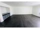 Large living area with dark hardwood floors and built-in cabinets at 4981 Alondra Dr, Las Vegas, NV 89118