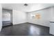 Bright living room featuring dark laminate flooring and a large window for natural light at 4981 Alondra Dr, Las Vegas, NV 89118