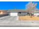 Ranch style home with attached garage and landscaped front yard at 5124 Brownwood Ave, Las Vegas, NV 89122