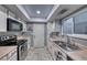 Bright kitchen with stainless steel appliances and white cabinets at 5124 Brownwood Ave, Las Vegas, NV 89122