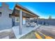 Covered patio features a table and chairs, providing an outdoor dining space at 5124 Brownwood Ave, Las Vegas, NV 89122