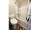 Clean bathroom featuring a bathtub, shower, toilet, and patterned rug at 5320 Duralite St # 102, Las Vegas, NV 89122