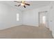 Spacious bedroom with carpeted floors and ceiling fan at 5400 Flowing Spring St, Las Vegas, NV 89122