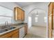 Kitchen with wood cabinets, granite counters, and white appliances at 5400 Flowing Spring St, Las Vegas, NV 89122