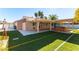 Backyard with hot tub, covered patio, and artificial turf at 57 Marion Dr, Las Vegas, NV 89110