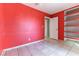 Red-walled bedroom with tiled floors and built-in shelving at 57 Marion Dr, Las Vegas, NV 89110