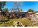 Ranch style home with mature landscaping and desert plants at 57 Marion Dr, Las Vegas, NV 89110