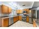 Modern kitchen with stainless steel appliances and wood cabinets at 57 Marion Dr, Las Vegas, NV 89110