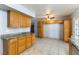 Kitchen with wood cabinets, granite counters, and tiled floors at 57 Marion Dr, Las Vegas, NV 89110