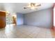 Open living room with tile floors and kitchen access at 57 Marion Dr, Las Vegas, NV 89110