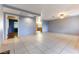 Open concept living room with light blue walls and tile floors at 57 Marion Dr, Las Vegas, NV 89110