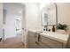 Stylish bathroom with gray vanity and arched mirror at 5904 Willowcreek Rd, North Las Vegas, NV 89031