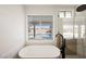 Bathroom with a large soaking tub and a view of the pool at 5904 Willowcreek Rd, North Las Vegas, NV 89031