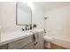 Modern bathroom with gray vanity, marble countertop, and bathtub at 5904 Willowcreek Rd, North Las Vegas, NV 89031