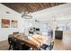 Open concept dining area with a large wooden table and modern chandelier at 5904 Willowcreek Rd, North Las Vegas, NV 89031