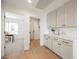 Bright hallway with light wood floors and built-in cabinets at 5904 Willowcreek Rd, North Las Vegas, NV 89031