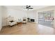 Bright living room with fireplace, hardwood floors, and sliding glass doors to patio at 5904 Willowcreek Rd, North Las Vegas, NV 89031