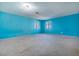 Spacious bedroom with light blue walls and carpeted floor at 6229 Cromwell Ave, Las Vegas, NV 89107