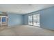 Living room with light blue walls and sliding glass doors at 6229 Cromwell Ave, Las Vegas, NV 89107