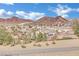 Community nestled in the mountains; view of numerous houses and surrounding landscape at 624 Via Colmo Ave, Henderson, NV 89011