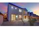 Backyard with gravel, a sliding glass door, and a partial view of neighboring houses at 624 Via Colmo Ave, Henderson, NV 89011