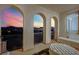 Covered balcony with arched openings offering stunning sunset and city views at 624 Via Colmo Ave, Henderson, NV 89011