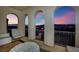 Covered balcony with arched openings offering stunning sunset and city views at 624 Via Colmo Ave, Henderson, NV 89011