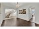 Elegant dining room with hardwood floors and curved staircase at 624 Via Colmo Ave, Henderson, NV 89011