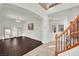 Spacious entryway with dark hardwood floors and curved staircase at 624 Via Colmo Ave, Henderson, NV 89011