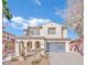 Two-story house with gray garage doors and desert landscaping at 624 Via Colmo Ave, Henderson, NV 89011